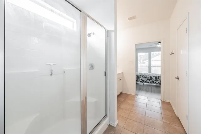a bathroom with a glass shower door