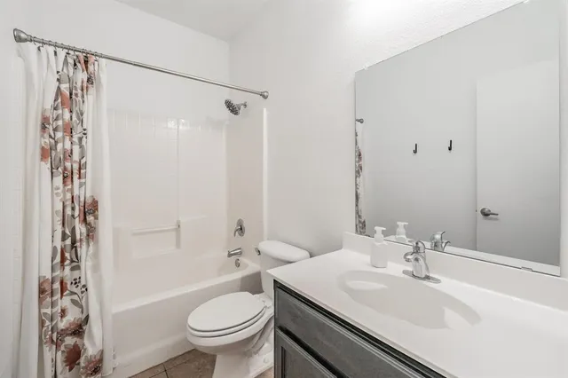 a bathroom with a sink toilet and mirror