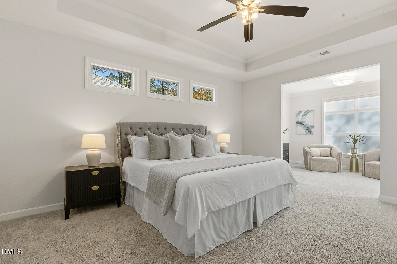 1345 Catlette Street Apex, NC 27523 - Photo 31 of 74 a spacious bedroom with a bed and a chandelier