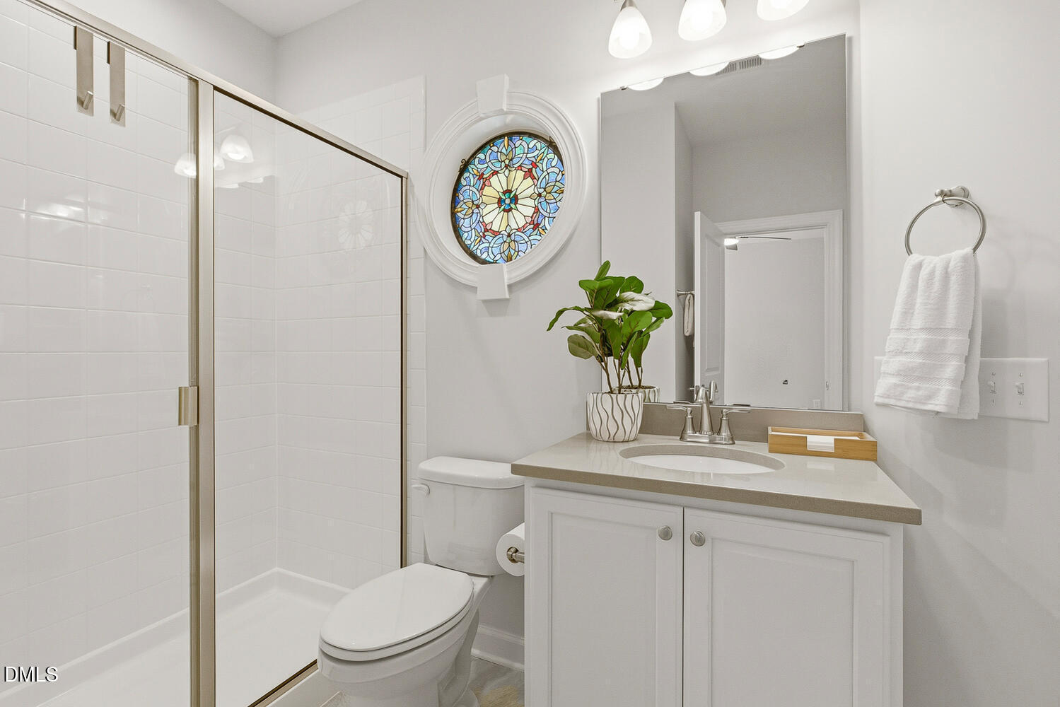 1345 Catlette Street Apex, NC 27523 - Photo 46 of 74 a bathroom with a toilet sink vanity and mirror