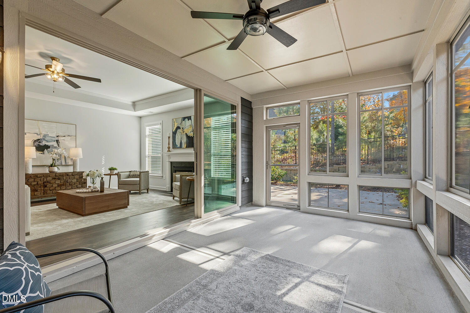1345 Catlette Street Apex, NC 27523 - Photo 60 of 74 a living room with furniture a fireplace and a floor to ceiling window