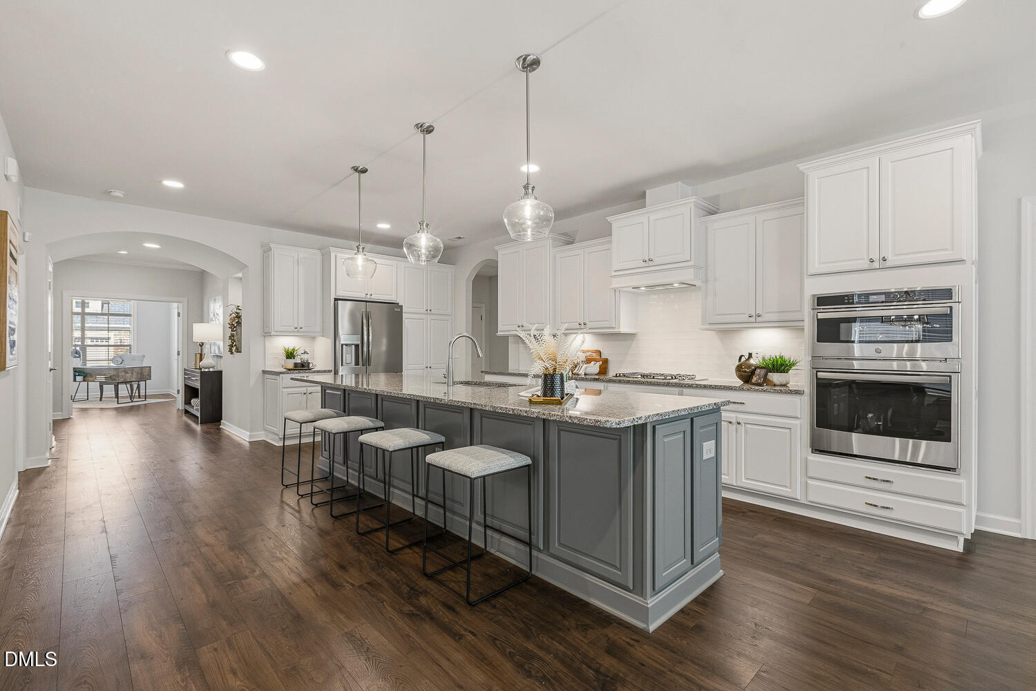 1345 Catlette Street Apex, NC 27523 - Photo 7 of 74 a kitchen with stainless steel appliances granite countertop a stove a sink dishwasher and a refrigerator with white cabinets