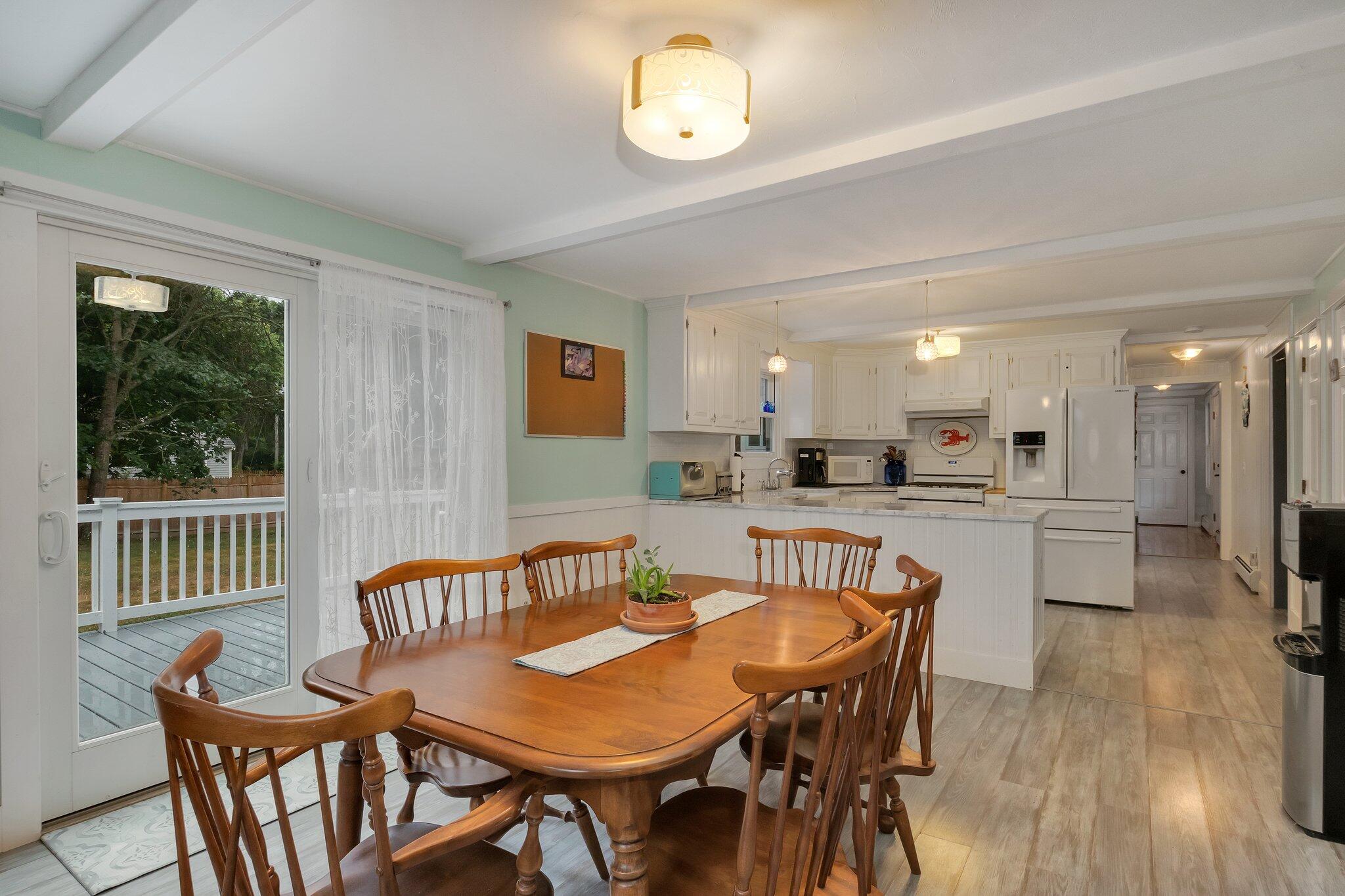 56 Mill Road East Sandwich, MA 02537 - Photo 14 of 63 a view of a dining room with furniture window and wooden floor