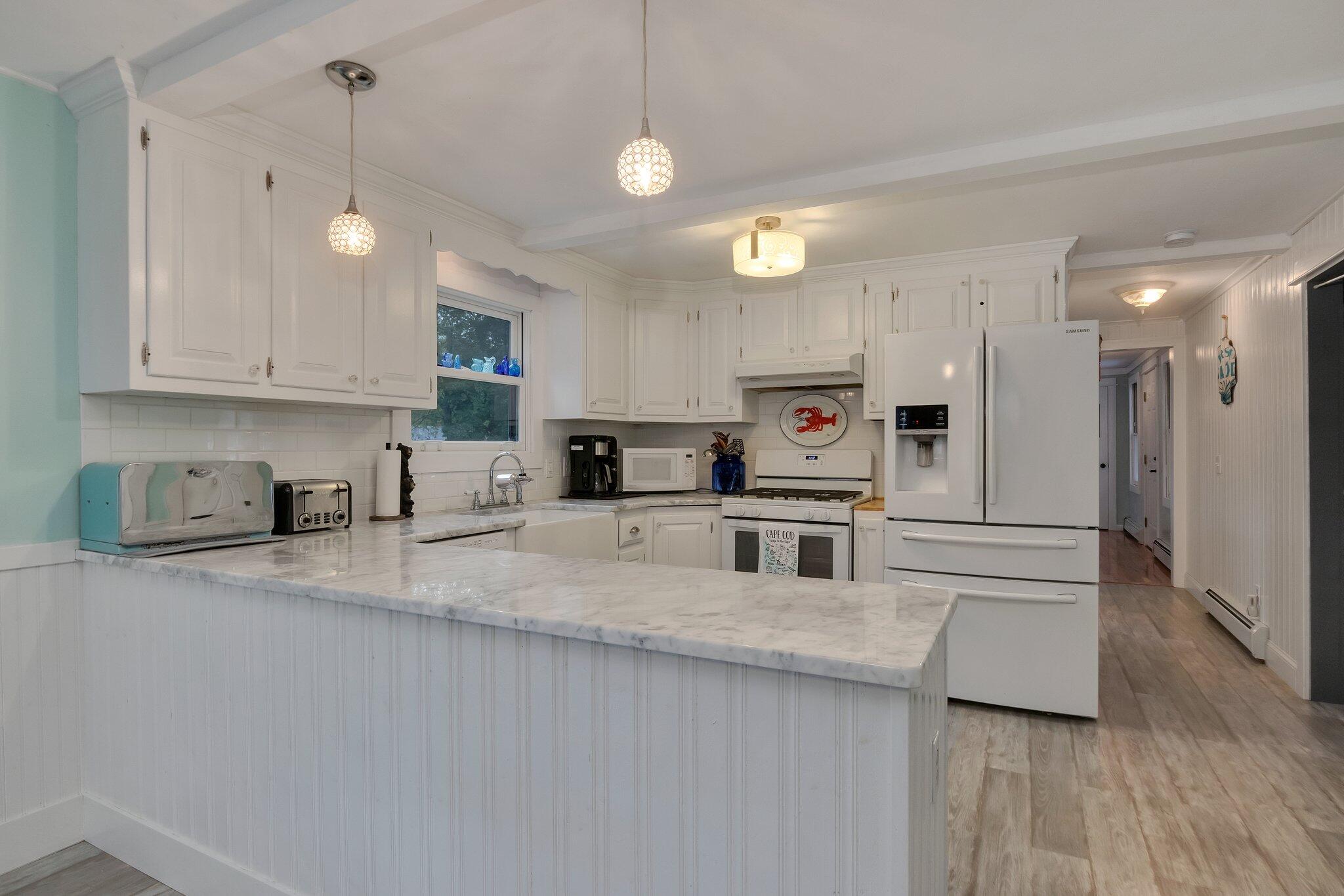 56 Mill Road East Sandwich, MA 02537 - Photo 15 of 63 a kitchen with stainless steel appliances granite countertop a sink refrigerator and cabinets