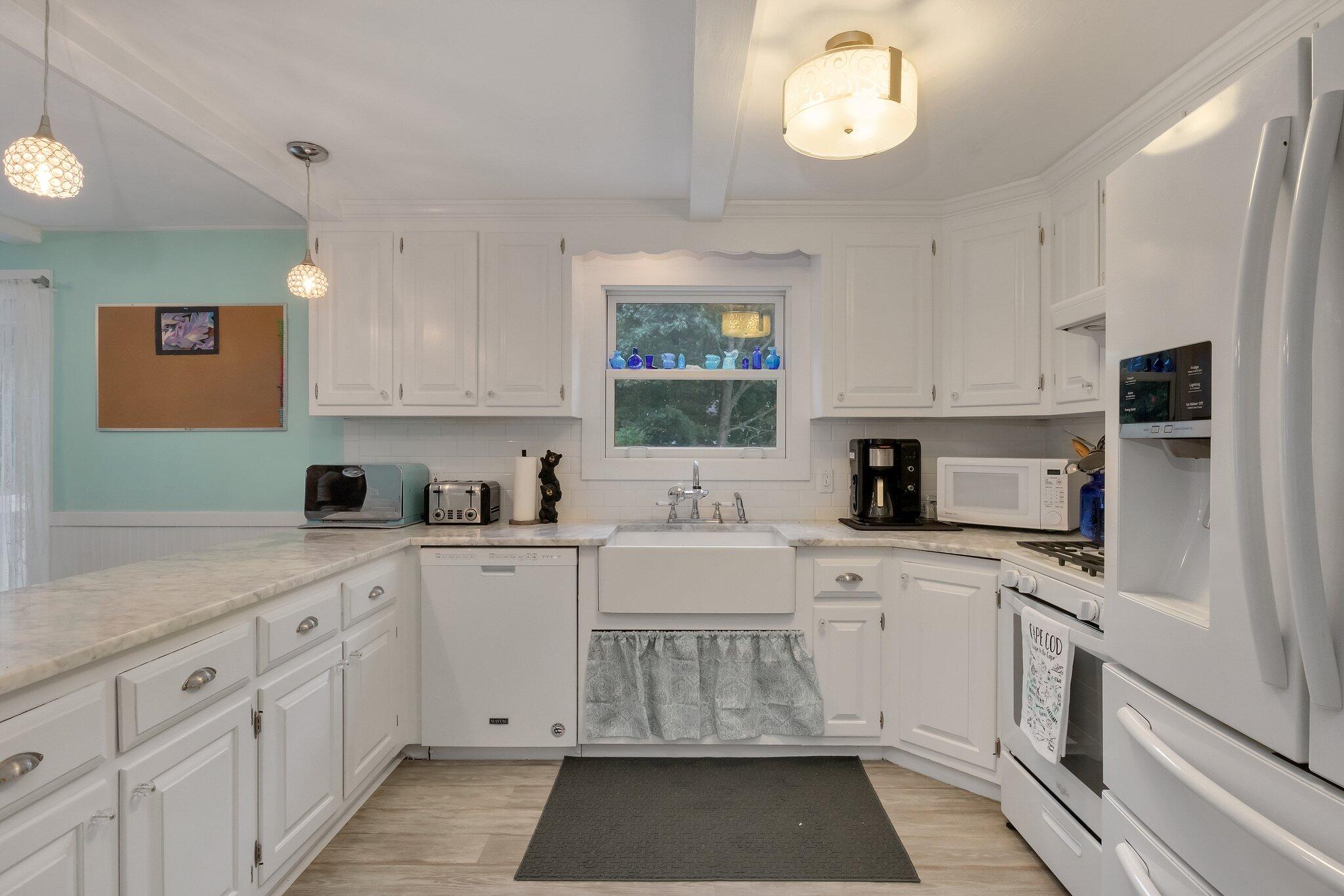 56 Mill Road East Sandwich, MA 02537 - Photo 19 of 63 a kitchen with a white cabinets and window