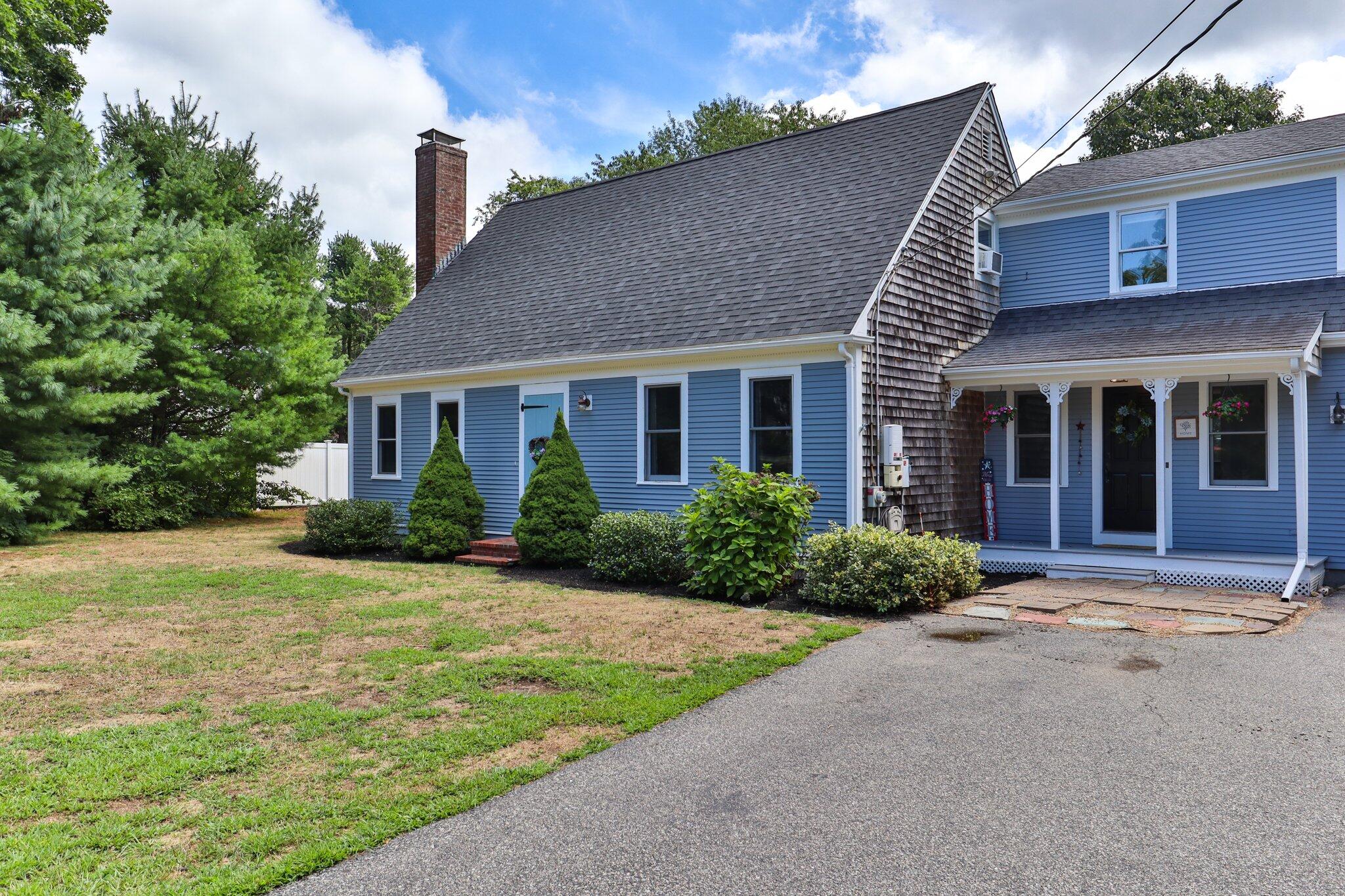 56 Mill Road East Sandwich, MA 02537 - Photo 2 of 63 a front view of a house with a yard and potted plants