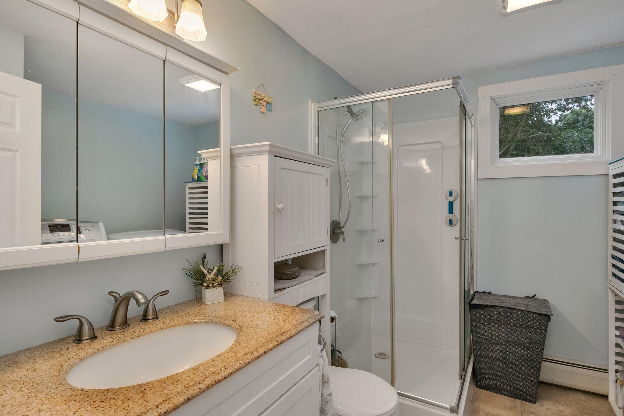 56 Mill Road East Sandwich, MA 02537 - Photo 25 of 63 a bathroom with a granite countertop sink toilet and shower