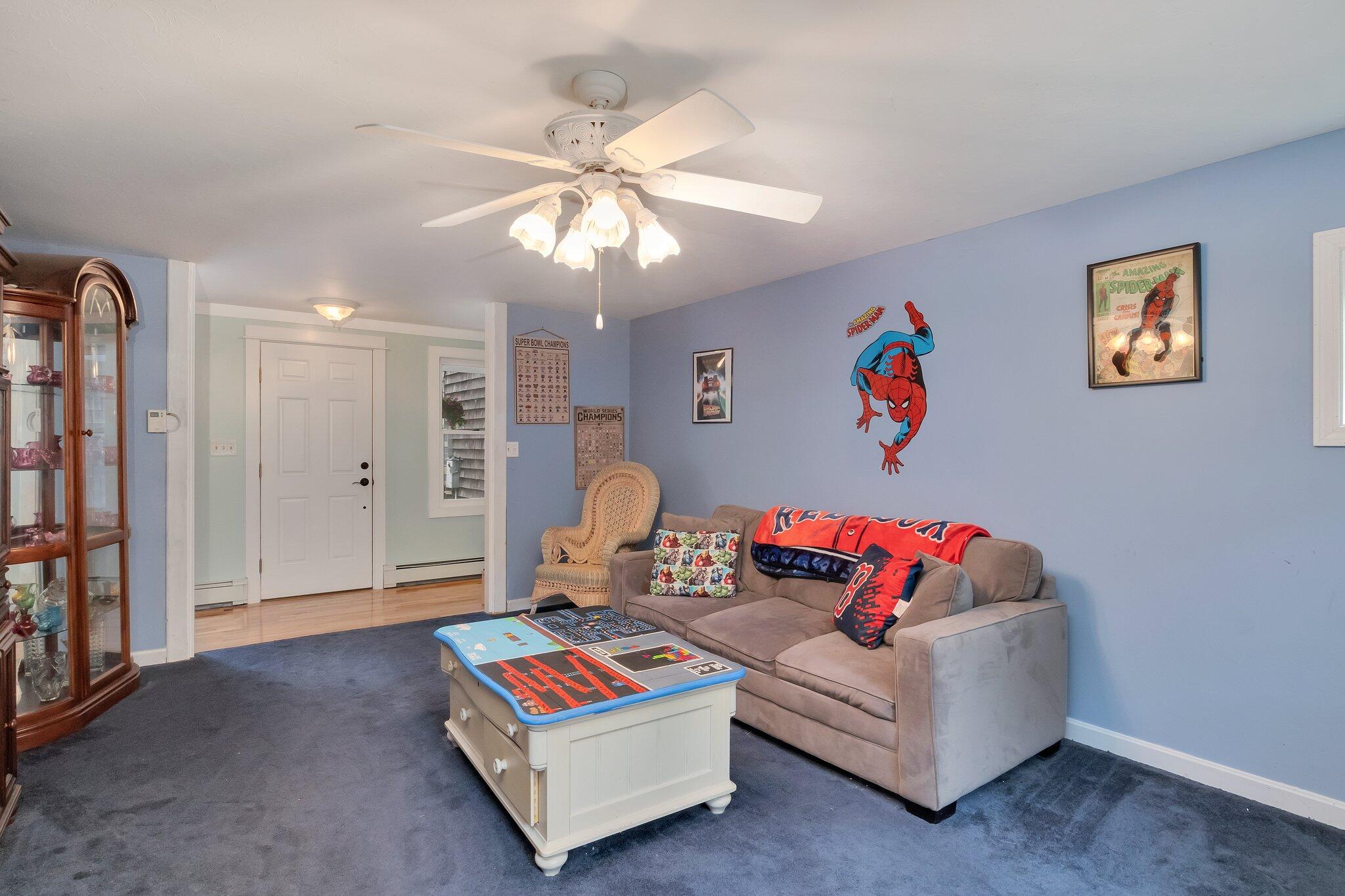 56 Mill Road East Sandwich, MA 02537 - Photo 29 of 63 a living room with furniture and a chandelier