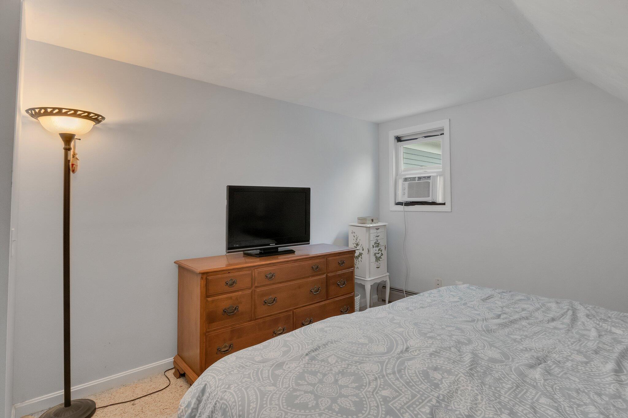 56 Mill Road East Sandwich, MA 02537 - Photo 39 of 63 a bedroom with a bed and a flat screen tv