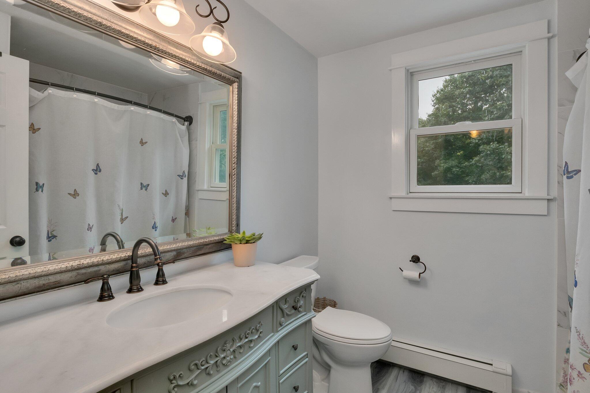 56 Mill Road East Sandwich, MA 02537 - Photo 40 of 63 a bathroom with a granite countertop sink and a toilet