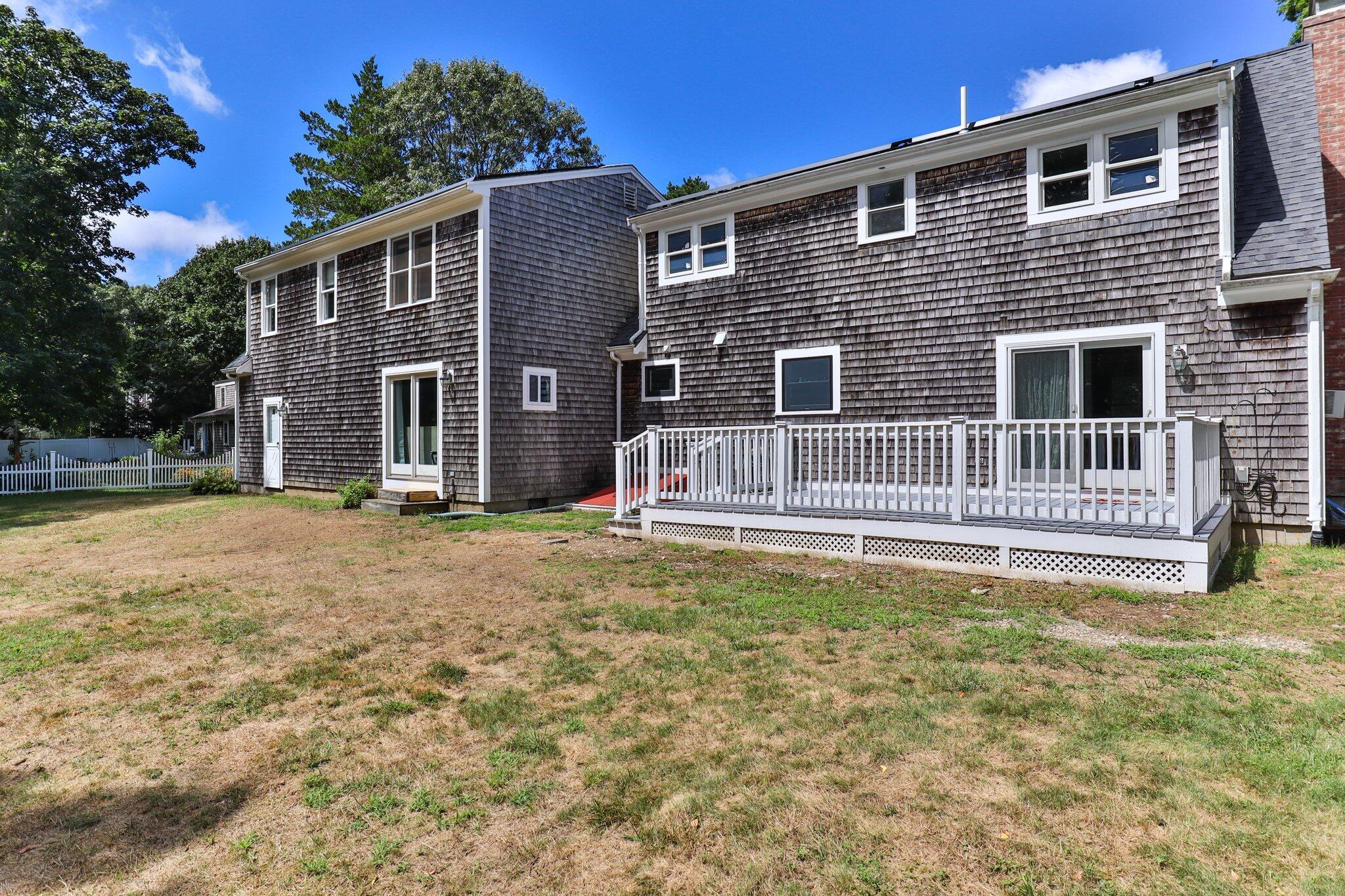 56 Mill Road East Sandwich, MA 02537 - Photo 46 of 63 a view of a house with a yard and wooden fence