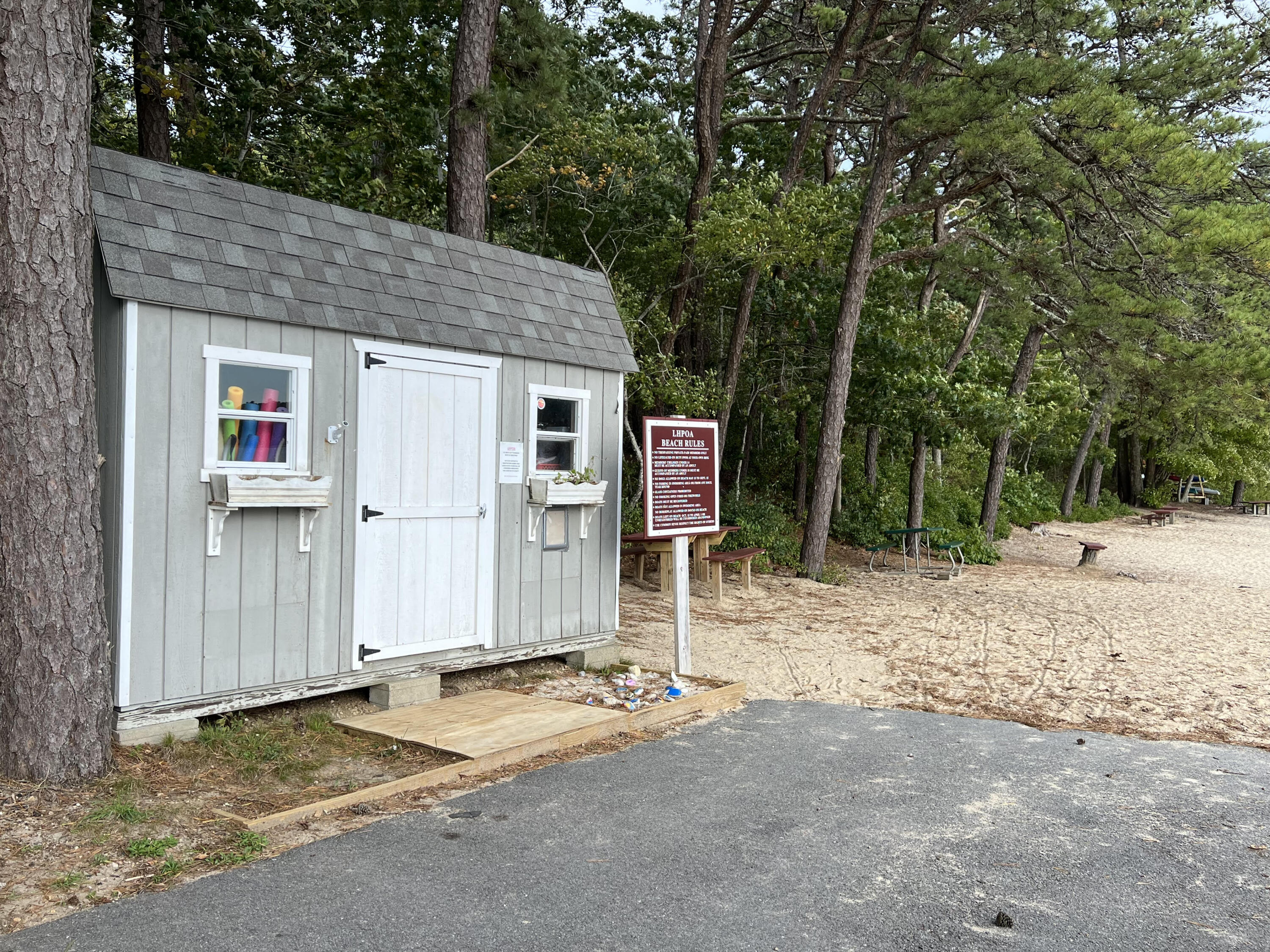 56 Mill Road East Sandwich, MA 02537 - Photo 60 of 63 a backyard of a house with barbeque oven and covered table and chairs