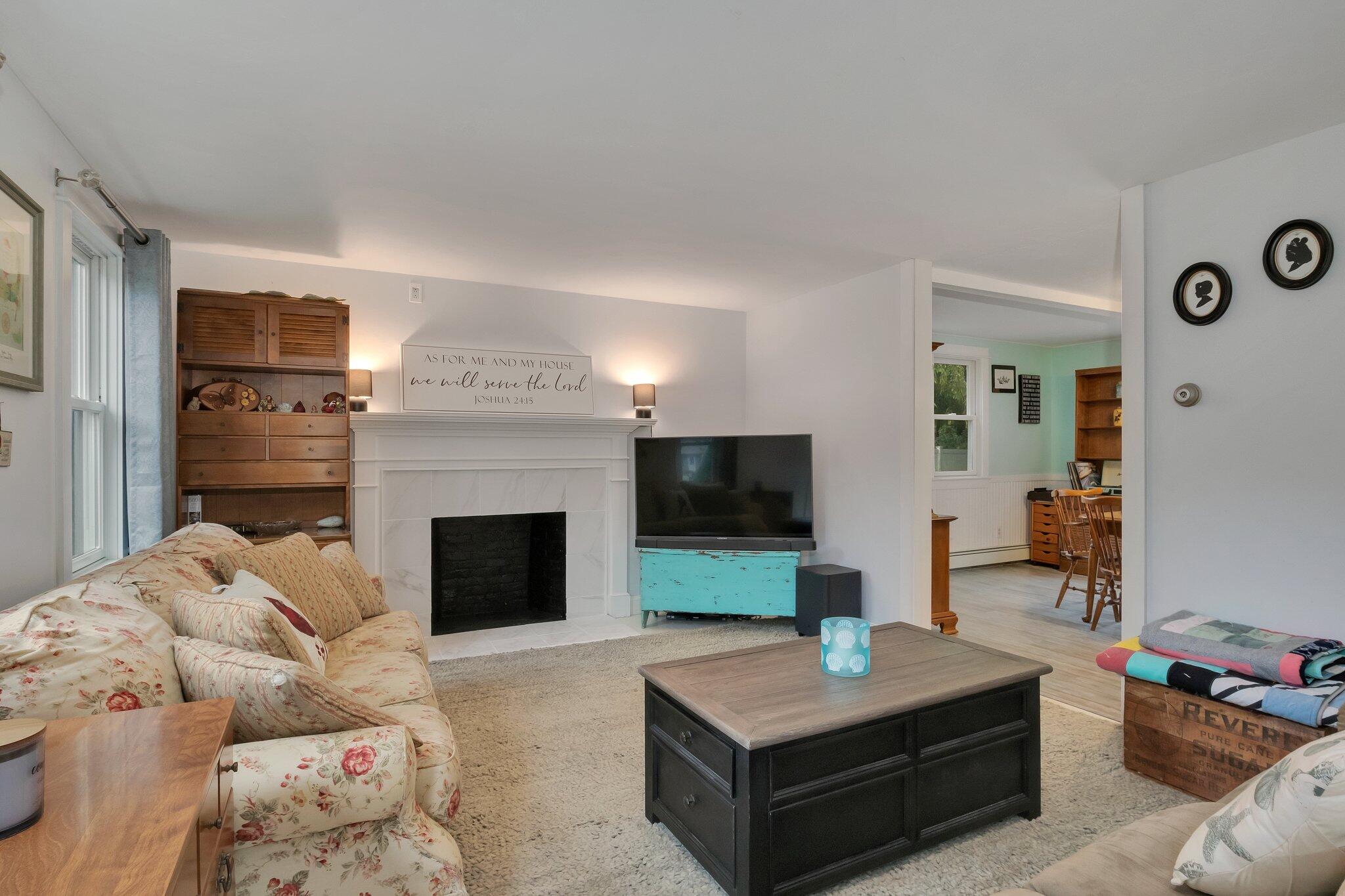 56 Mill Road East Sandwich, MA 02537 - Photo 7 of 63 a living room with furniture a fireplace and a flat screen tv