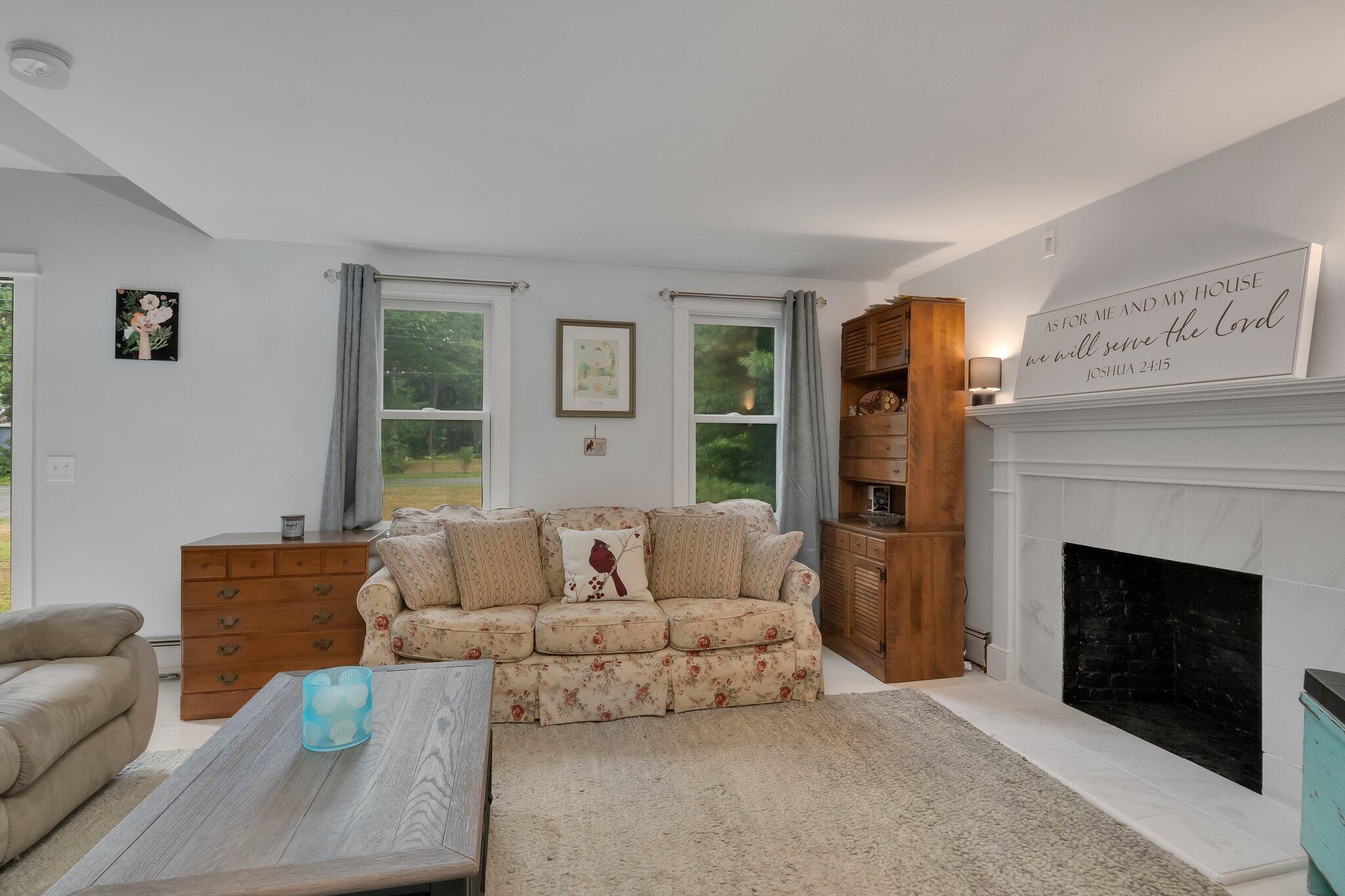 56 Mill Road East Sandwich, MA 02537 - Photo 8 of 63 a living room with furniture and a fireplace