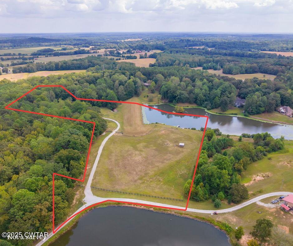 413 Law Lane Lexington, TN 38351 - Photo 3 of 25 an aerial view of a house with a lake view