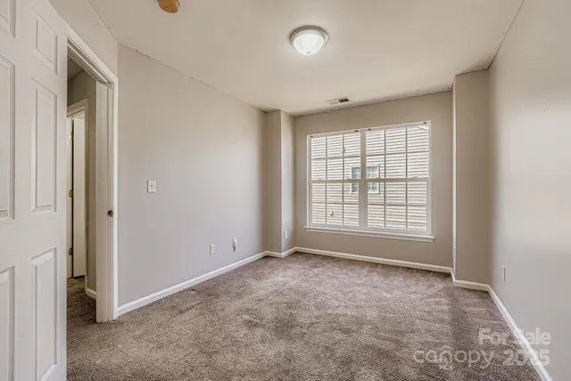 an empty room with a empty space and windows