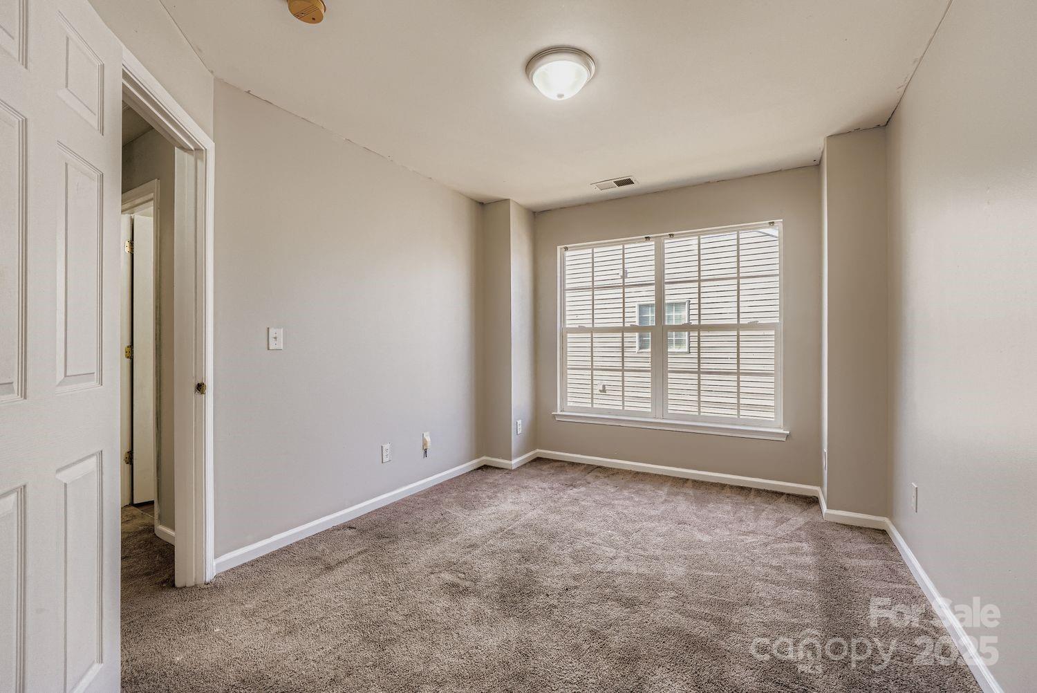 11609 Erwin Ridge Avenue Charlotte, NC 28213 - Photo 16 of 29 an empty room with a empty space and windows