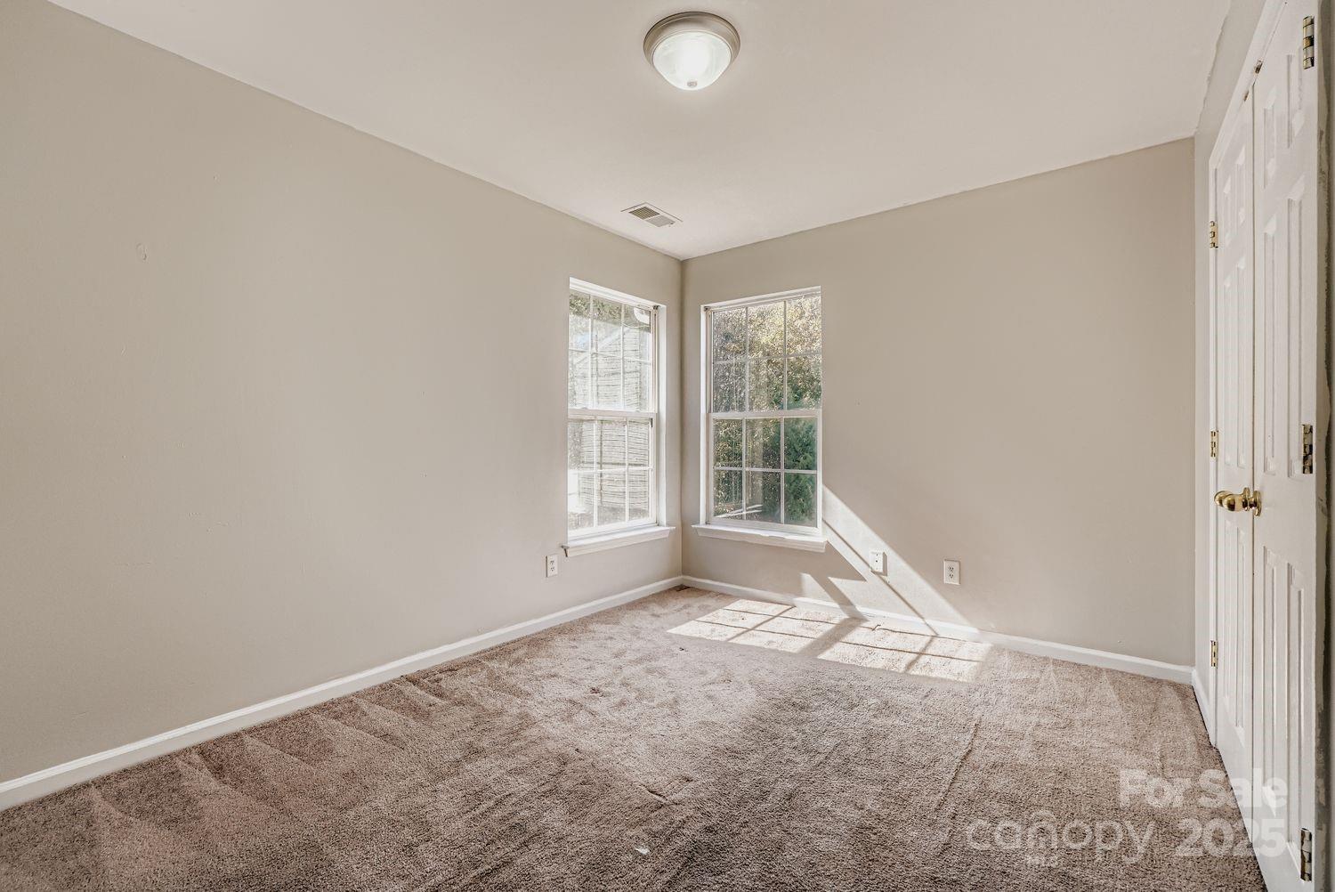 11609 Erwin Ridge Avenue Charlotte, NC 28213 - Photo 18 of 29 an empty room with windows