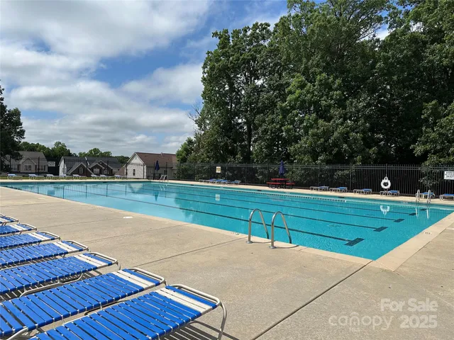 a view of a house with swimming pool and sitting area
