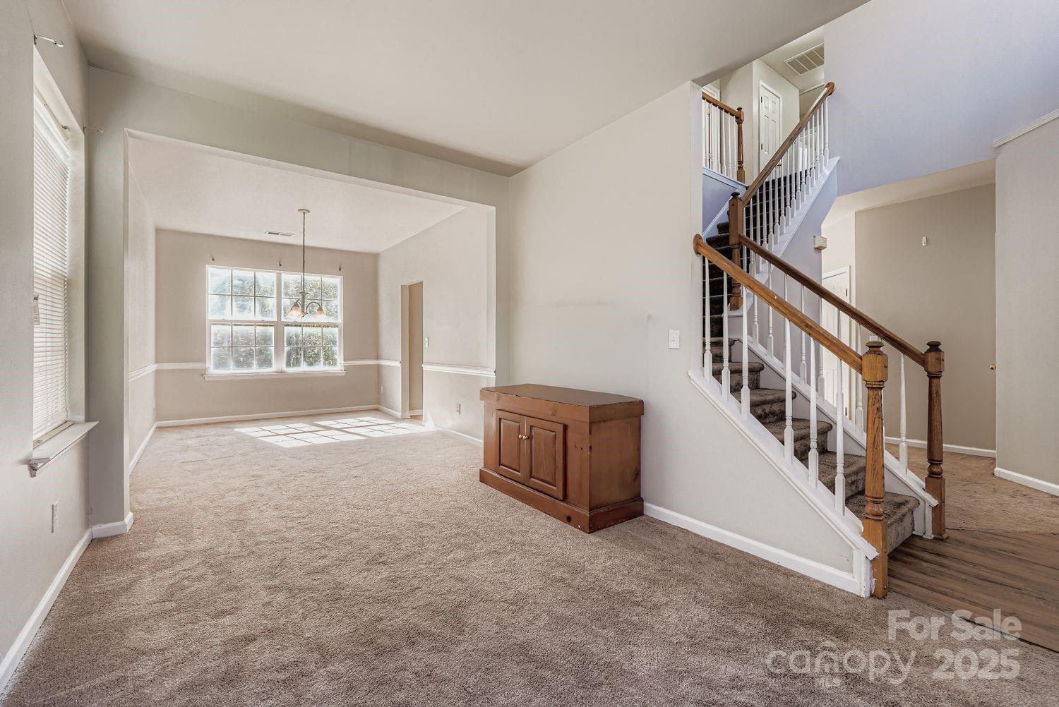 11609 Erwin Ridge Avenue Charlotte, NC 28213 - Photo 4 of 29 a view of an empty room with stairs and a window