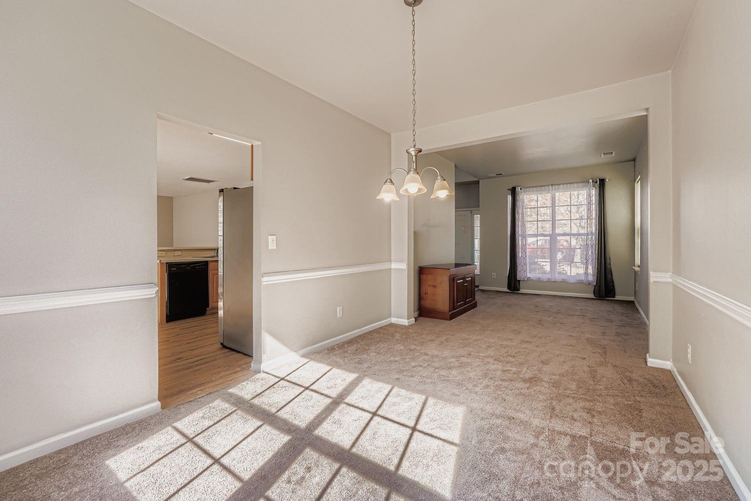 11609 Erwin Ridge Avenue Charlotte, NC 28213 - Photo 5 of 29 a view of a livingroom with a chandelier fan and windows