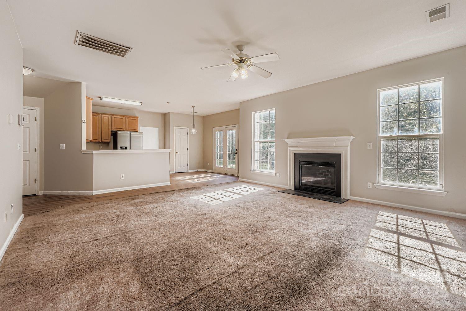 11609 Erwin Ridge Avenue Charlotte, NC 28213 - Photo 9 of 29 an empty room with windows and fireplace