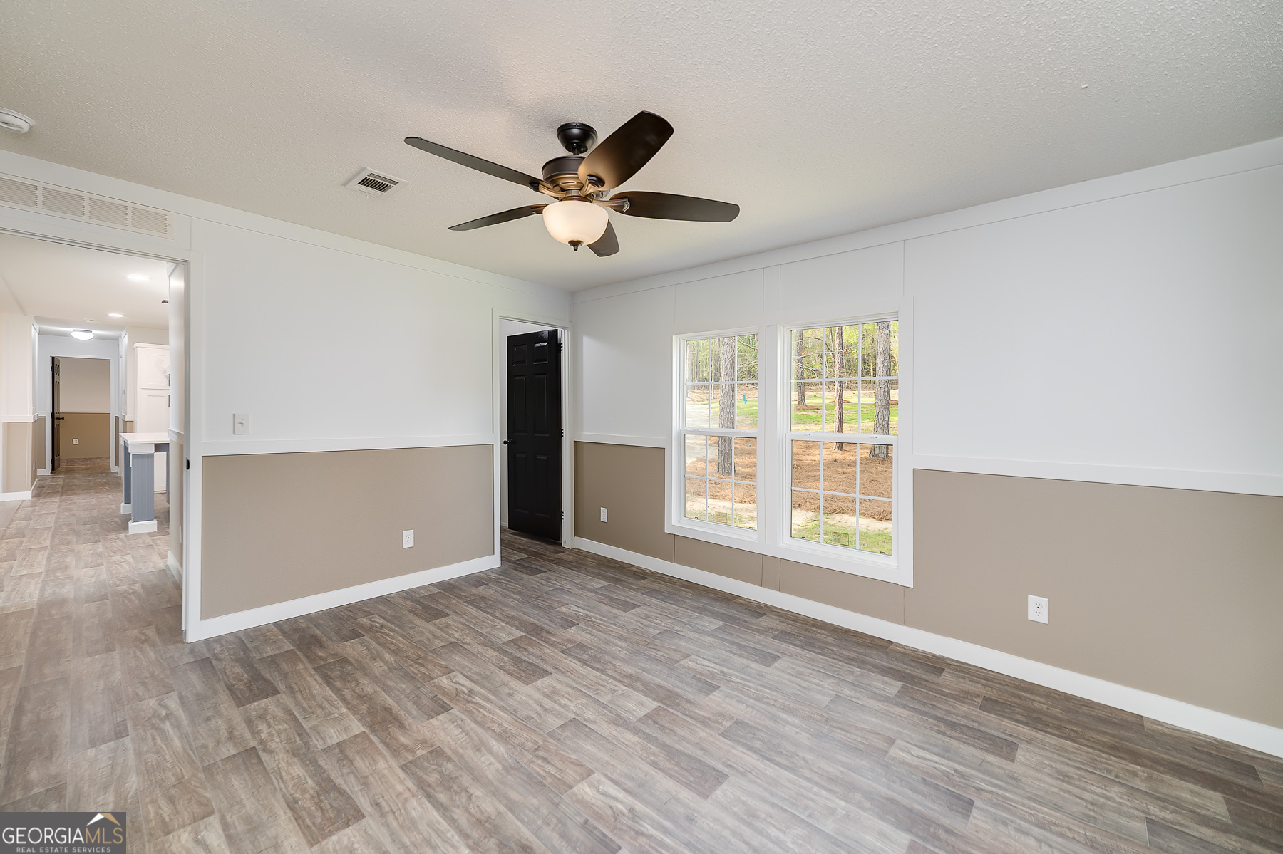 595 Barnetts Bridge Road Jackson, GA 30233 - Photo 26 of 47 a view of an empty room with window and wooden floor