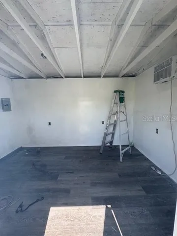 a view of a room with wooden floor