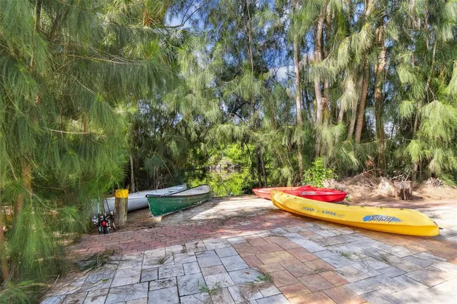 a view of patio with table and chairs and potted plants