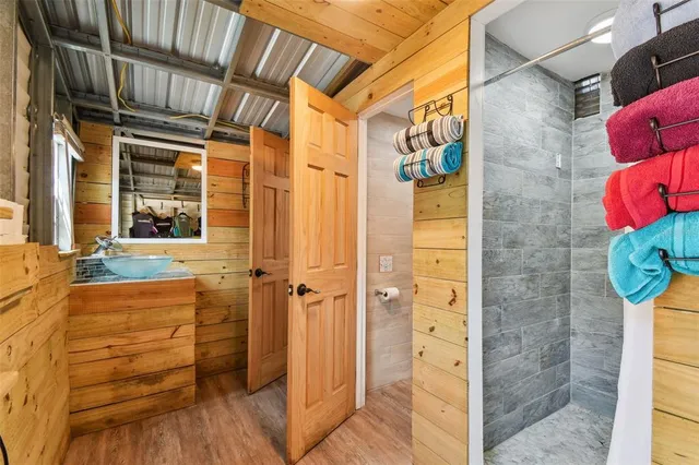 a roof deck with table and chairs and potted plants with sky view