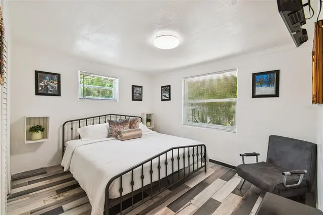 a bedroom with a bed and a couch