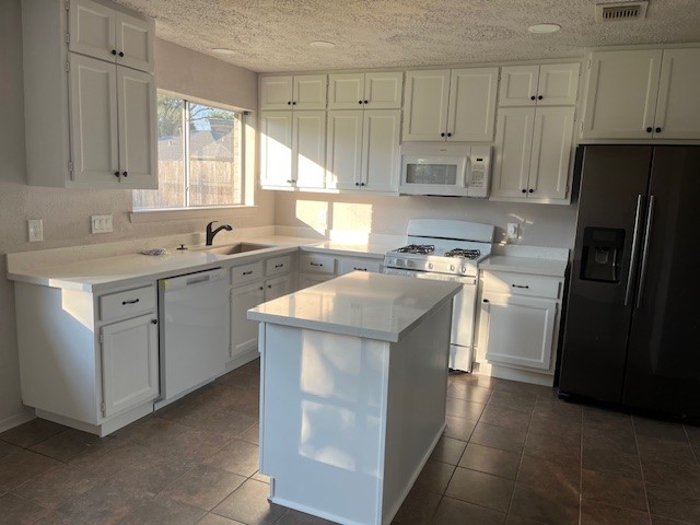 467 Buoy Road Webster, TX 77598 - Photo 4 of 23 kitchen with quartz counters and hand-crafted cabinets. Lots of extra cabinets were added using water resistant wood.