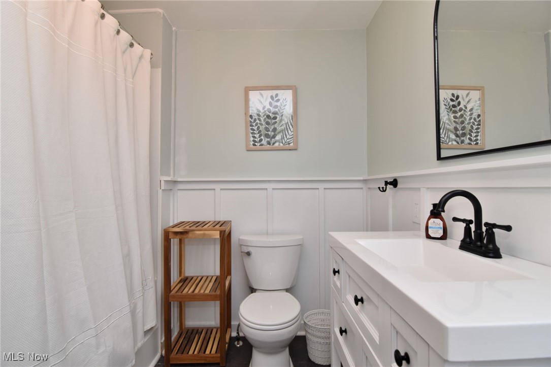 1767 Edgefield Road Lyndhurst, OH 44124 - Photo 11 of 17 Bathroom with a shower with curtain, vanity, and toilet