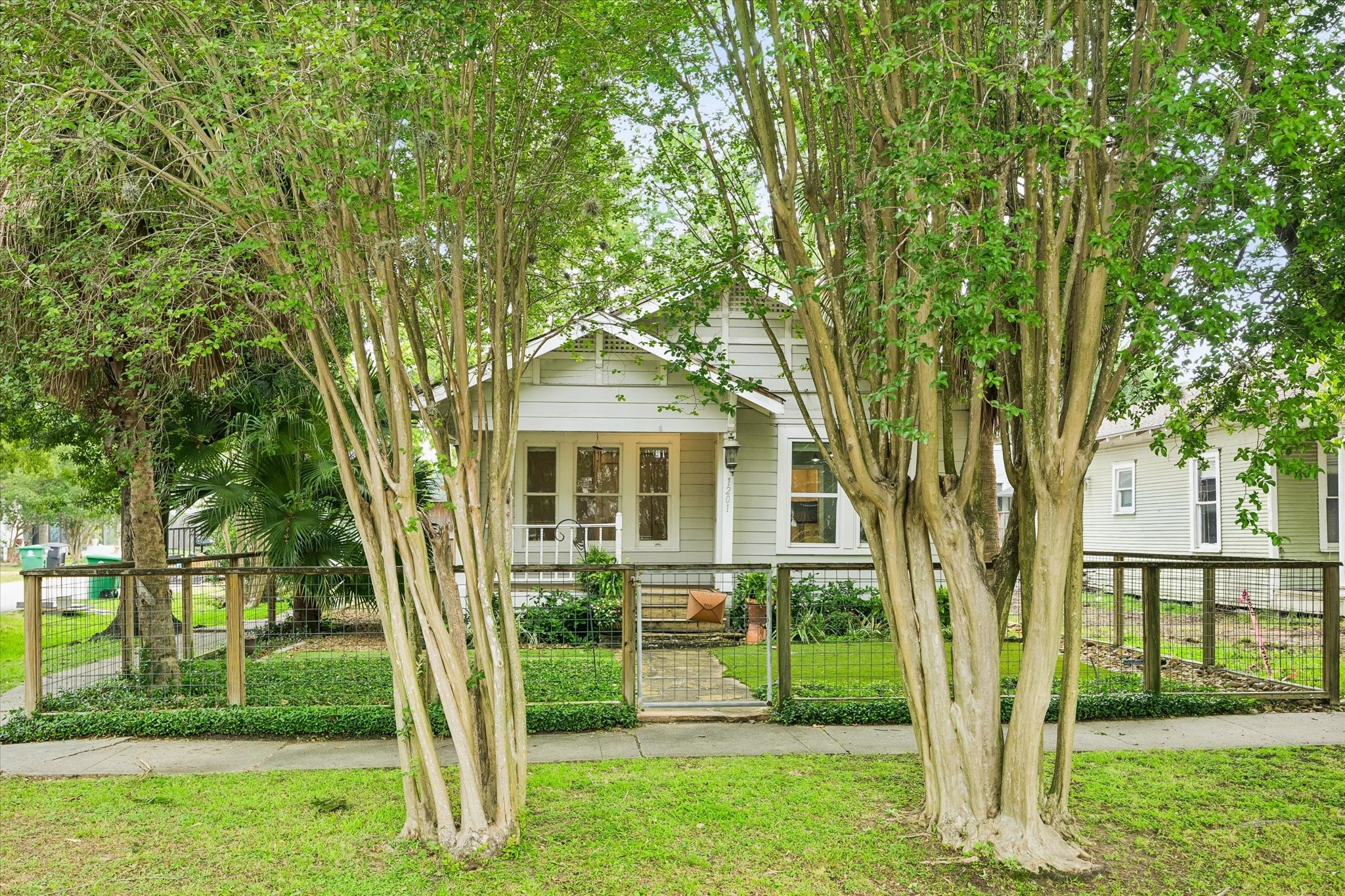 1201 Tulane Street Houston, TX 77008 - Photo 4 of 31 This charming 1930s Craftsman feels right at home in Historic Houston Heights, with a fenced front yard, covered porch, mature trees, and timeless bungalow character. It is the kind of home that makes walkable city living feel warm, personal, and full of everyday charm.