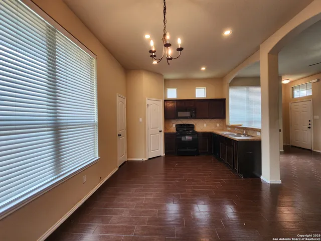 a view of kitchen with refrigerator and stove