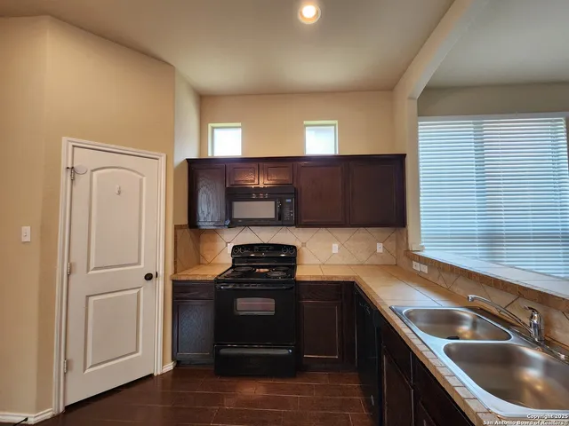 a kitchen that has a sink and a stove