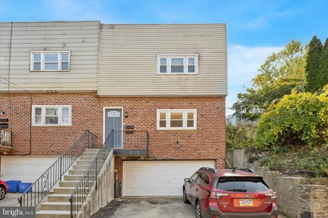 a front view of a house with parking