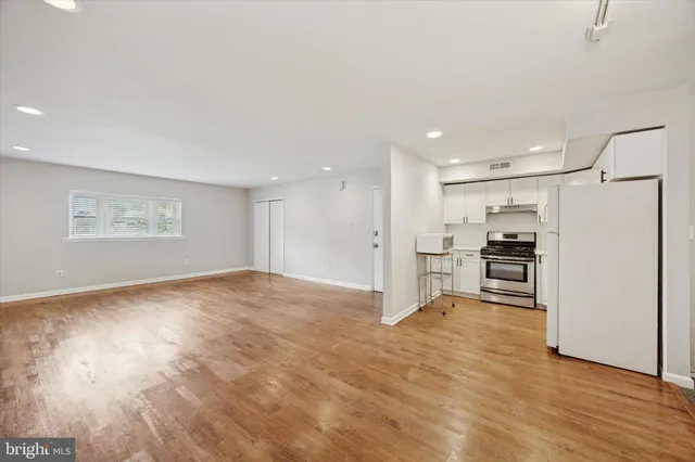 a view of a kitchen with a sink and a refrigerator