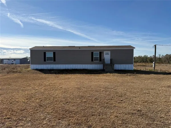 a view of front door and yard