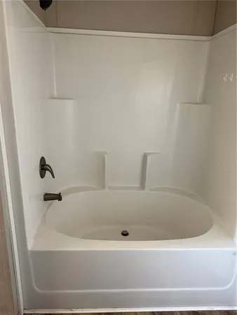 a white bath tub and shower