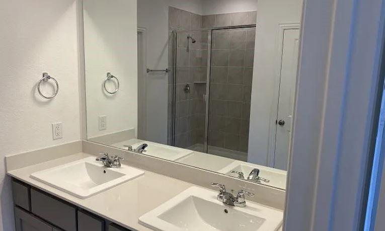 1736 Everglades Drive Forney, TX 75126 - Photo 5 of 11 a bathroom with a sink and a mirror