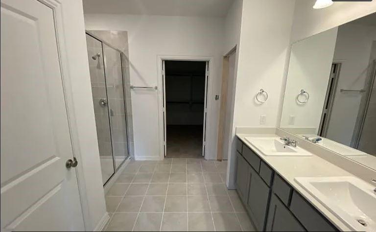 1736 Everglades Drive Forney, TX 75126 - Photo 6 of 11 a bathroom with a double vanity sink a mirror and a bathtub