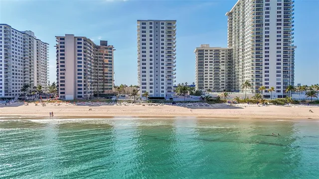 a swimming pool with buildings in the background