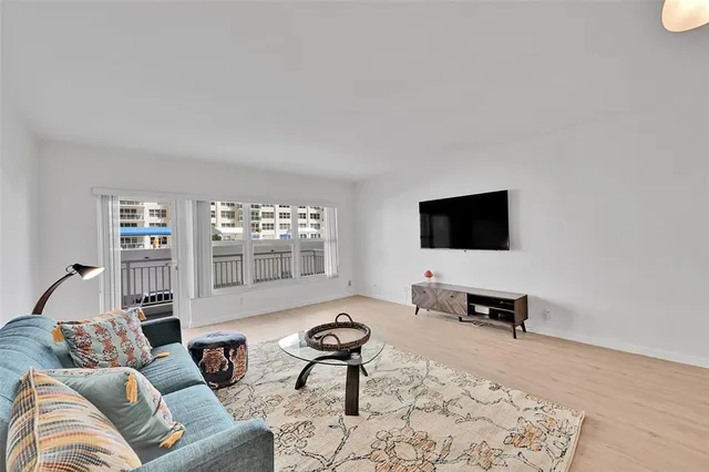 a kitchen with cabinets wooden floor and stainless steel appliances