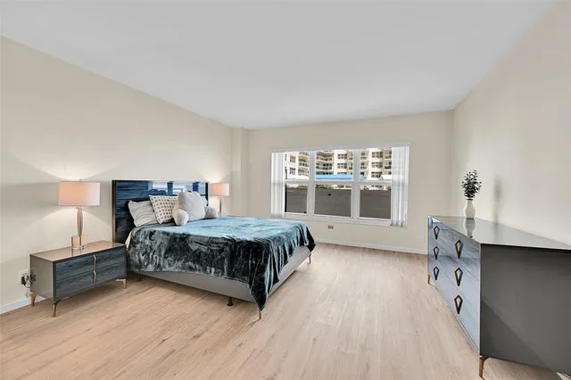 a spacious bathroom with a granite countertop tub sink and mirror