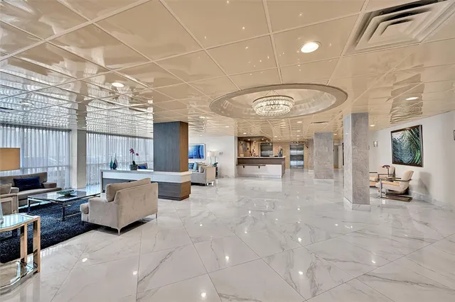 a lobby with furniture and a flat screen tv