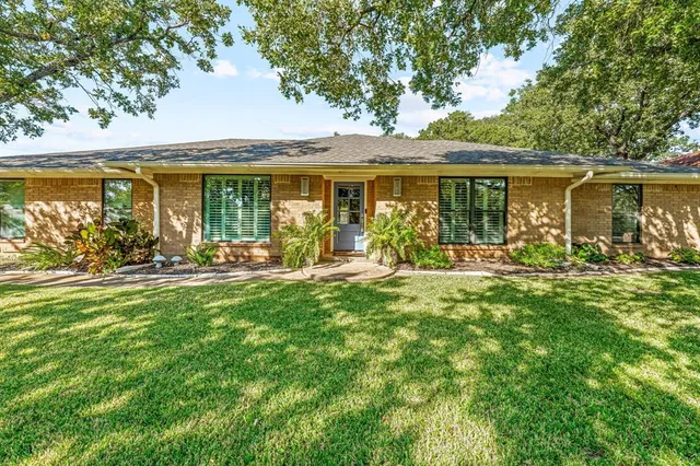 a front view of house with yard patio and green space