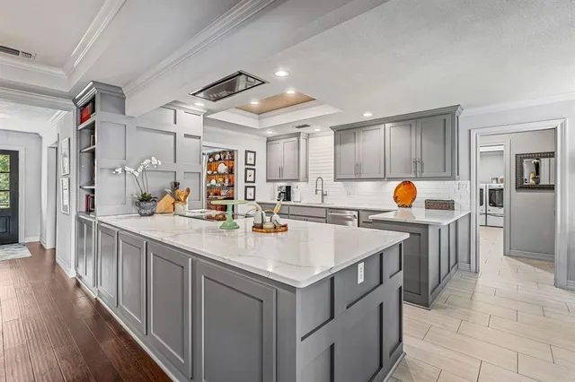 a kitchen with stainless steel appliances granite countertop lots of counter top space and cabinets
