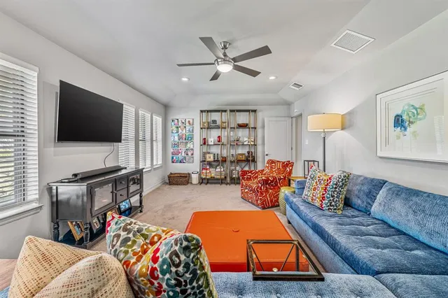 a spacious bedroom with a bed and a large mirror