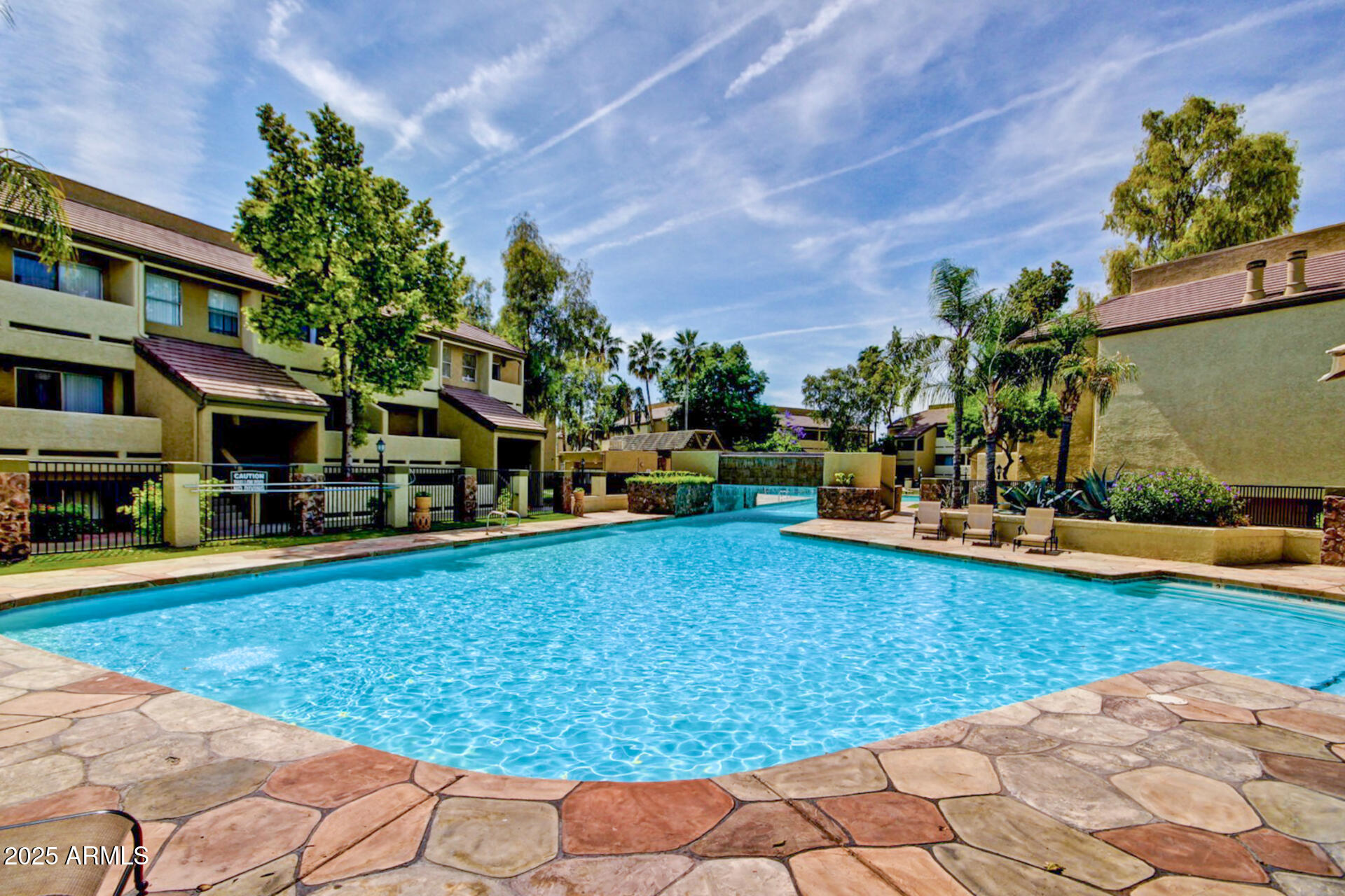 a swimming pool view with a seating space and a garden